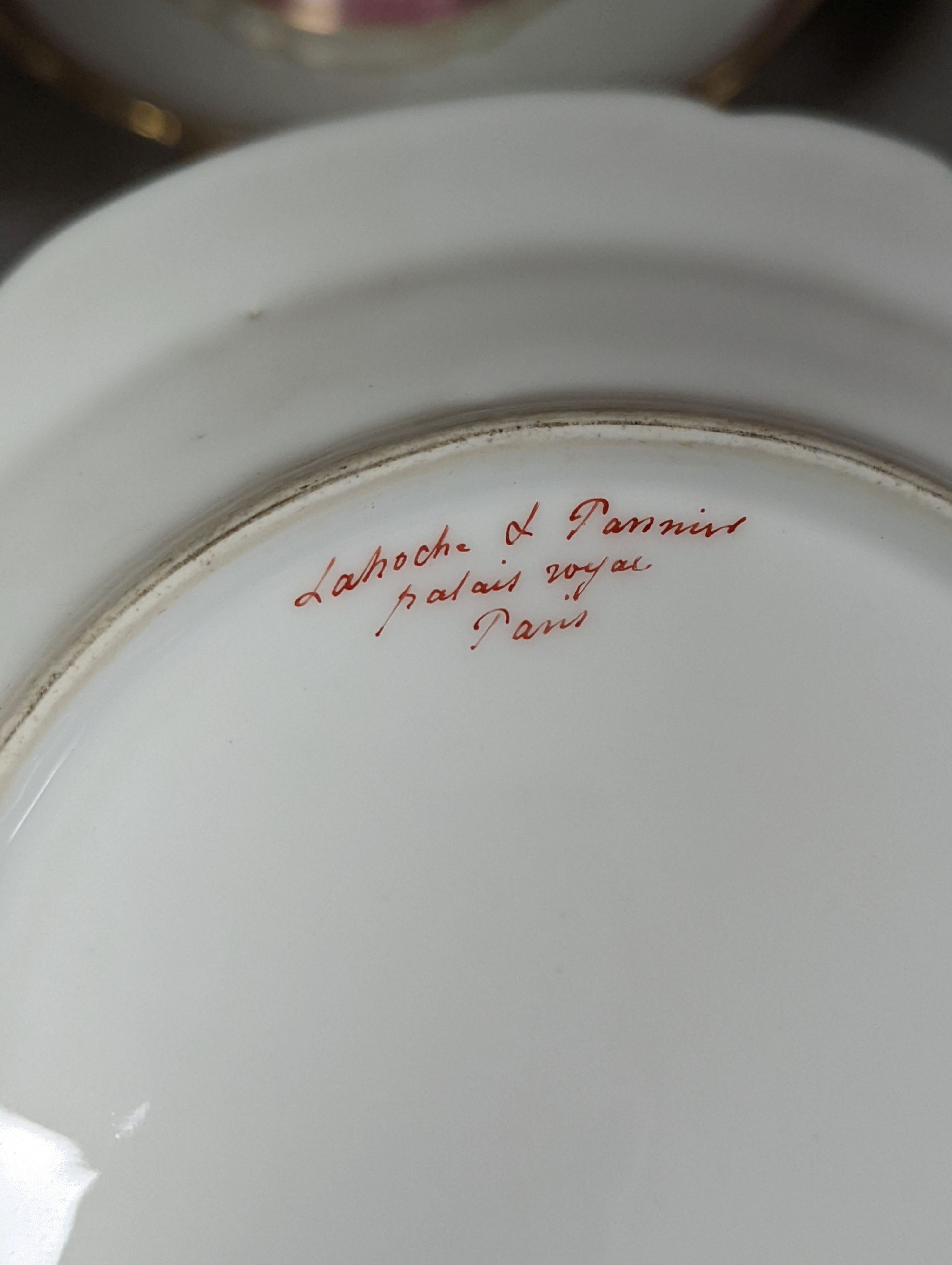 A late 19th century Paris porcelain floral part dessert service, with 2 pairs of comports, a three tier cake stand and eleven dishes.